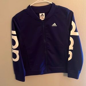 An Adidas jacket with Adidas just on the arms very comfy to wear.